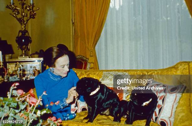 The Duchess of Windsor, Wallis Simpson, with her pug dogs at her home in Bois de Boulogne near Paris, France 1974.