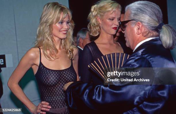 Models Claudia Schiffer and Eva Herzigova wwith couturier Karl Lagerfeld, Germany, 1992.