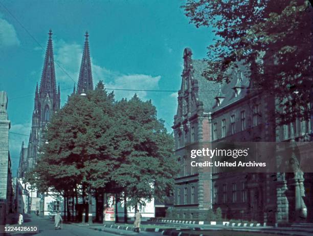 View to the cathedral at Cologne, from Burgmauer street, Roman fountain and arsenal , Germany 1950s.