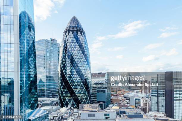 london skyline with the gherkin skyscraper reflecting in glass skyscrapers, england, uk - london skyline stock pictures, royalty-free photos & images