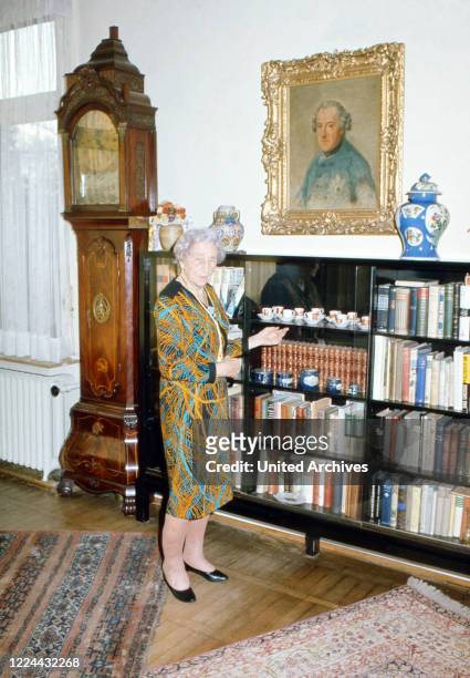 Princess Victoria Louise of Prussia, Duchess of Brunswick Lueneburg, at the bookshelf in her house in Brunswick, Germany, 1974.