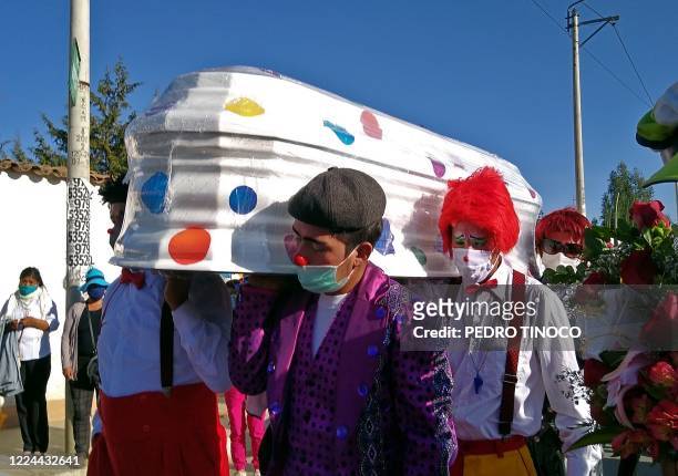 Admirers of Peruvian clown William Rojas, known professionally as Chupetin, carry his coffin during his funeral procession to the Eternal Hope...