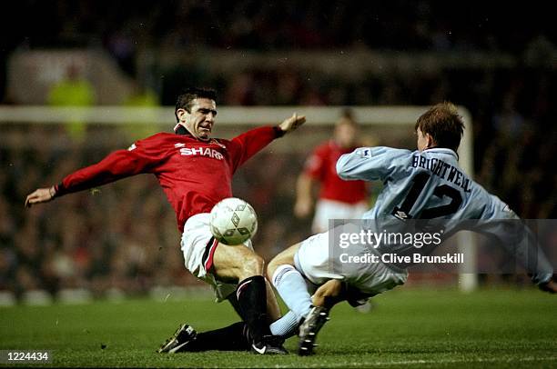 Eric Cantona of Manchester United takes on Ian Brightwell of Manchester City during an FA Carling Premiership match at Maine Road in Manchester,...