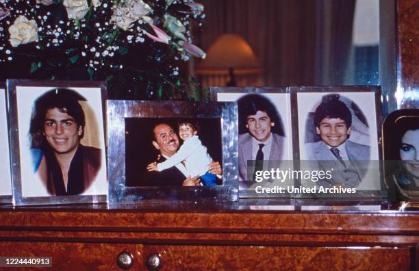 Family photographs from Adnan Khashoggi at his desk in his office at Olympic Tower in New York, USA 1986.