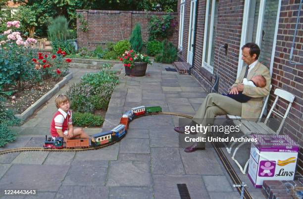 Historian Friedrich Wilhelm Prince of Prussia with his baby son Joachim Albrecht and his son Friedrich Wilhelm playing with a model train at Bremen,...