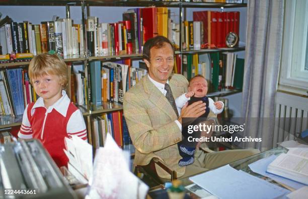 Historian Friedrich Wilhelm Prince of Prussia with his baby son Joachim Albrecht and son Friedrich Wilhelm in the office at Bremen, Germany, 1984.