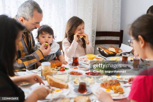 turkisk familj äter frukost hemma - turkish ethnicity bildbanksfoton och bilder