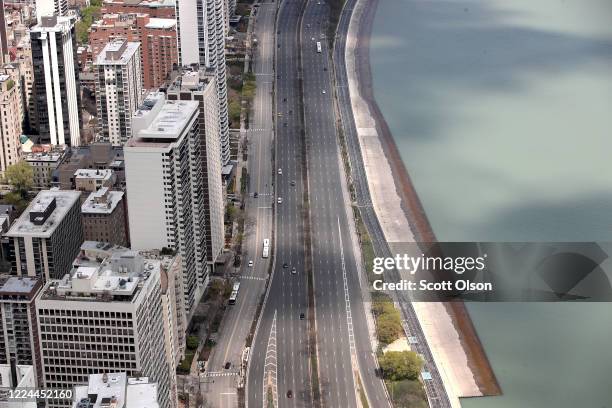 View from the 360 Chicago observation deck shows a nearly-empty Lake Shore Drive and a deserted lakefront on May 12, 2020 in Chicago, Illinois. The...