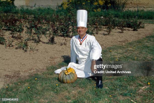 French high quality chef Paul Bocuse with a pumpkin at the garden in Collonges-au-Mont-d'Or, France 1995.