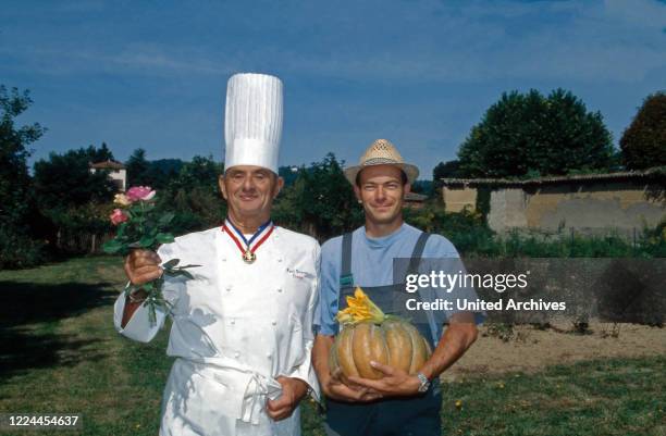 French high quality chef Paul Bocuse with pumpkin and gardener at Collonges-au-Mont-d'Or, France 1995.