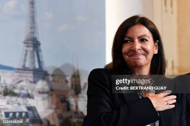 Paris' Mayor Anne Hidalgo reacts, during a Paris council meeting on July 3, 2020 at the Paris city hall, as she arrives on stage following her...