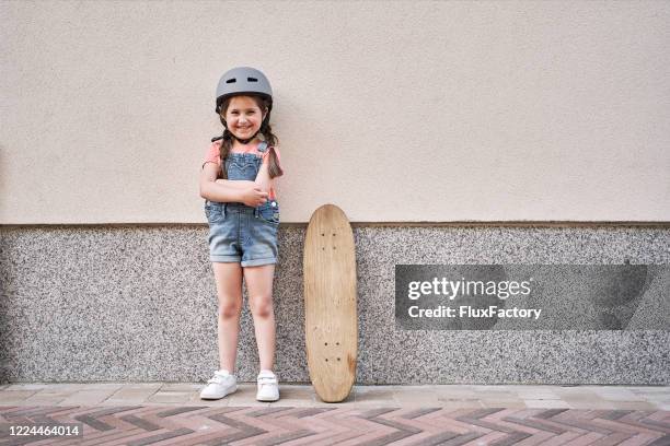 confident little female skateboarder - learning agility stock pictures, royalty-free photos & images