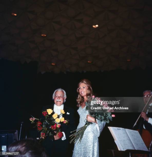 Joan Kennedy, wife of American senator Edward Ted Kennedy, with orchestra conductor Arthur Fiedler at a soiree while visiting Bonn, Germany, 1971.