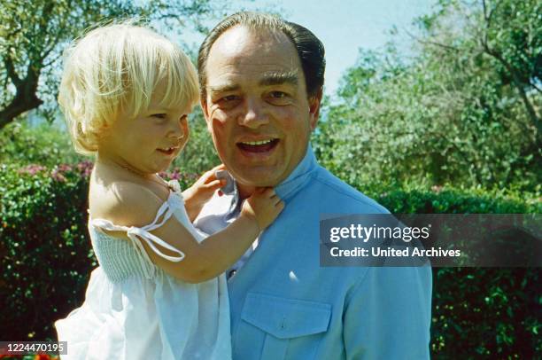 Rudolf Count of Schoenburg Glauchau playing with his daughter Sophie at Marbella, Spain, 1982.