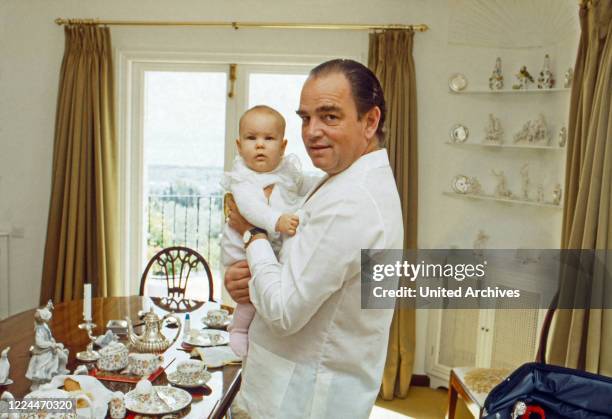 Rudolf Count of Schoenburg Glauchau playing with his daughter Sophie, Germany, 1980.