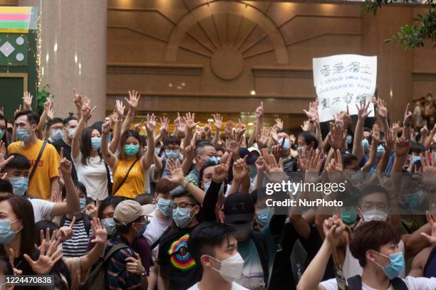 Pro-democracy protesters march on a street as they take part in a demonstration on July 1, in Hong Kong, China.