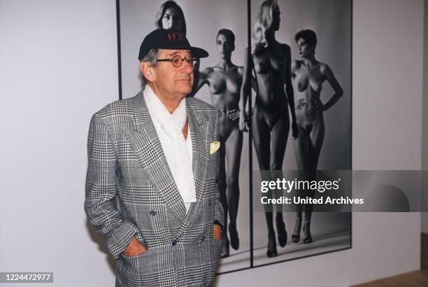 Helmut Newton, German-Australian photographer, in front of one of his pictures at one of his exhibitions, Germany circa 1998.