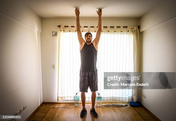 05m tall Argentine basketball player Kevin Hernandez trains in isolation in his 10 square meters living room on May 12, 2020 in Buenos Aires,...