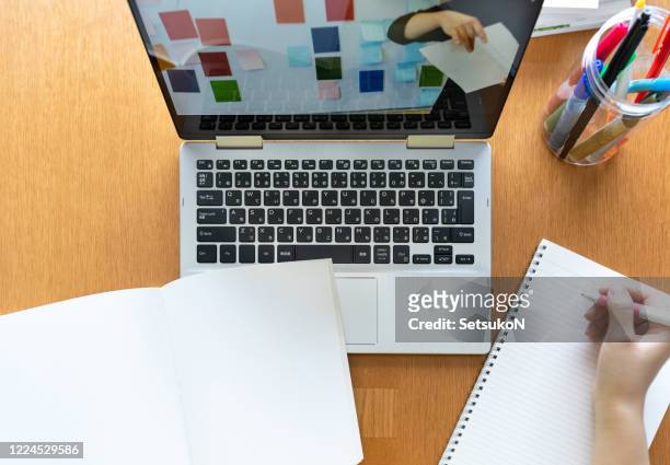 asian teenage girl studying with video online lesson at home - workbook stock pictures, royalty-free photos & images