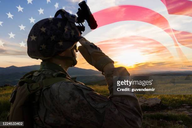 silhouette of a solider saluting against us flag at sunrise - infantry stock pictures, royalty-free photos & images