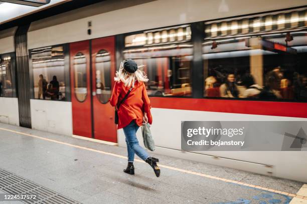 woman running to catch the train - red leaves stock pictures, royalty-free photos & images