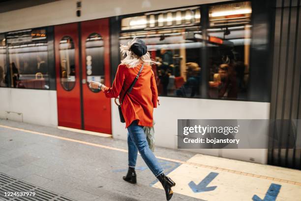 woman running to catch the train - catching train stock pictures, royalty-free photos & images