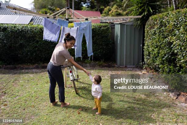mum and daughter at home doing the laundry - washing line stock pictures, royalty-free photos & images