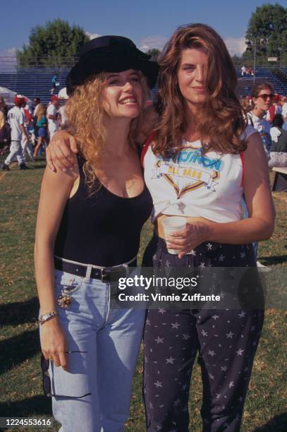 American actress Kelly Preston and American actress Kirstie Alley attend Narconon's 1991 Celebrity Softball Game, held at the Tom Bradley Stadium, in...