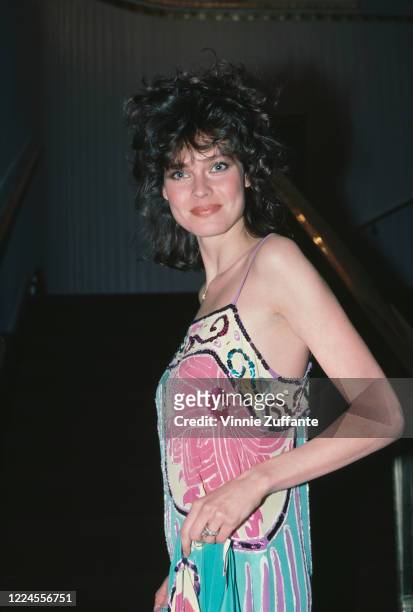 America fashion model and actress Carol Alt wearing a patterned spaghetti strap dress at an event, circa 1985.