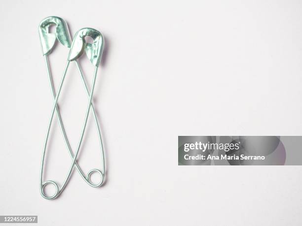 sewing safety pins representing two people hugging - ana maria parera bildbanksfoton och bilder