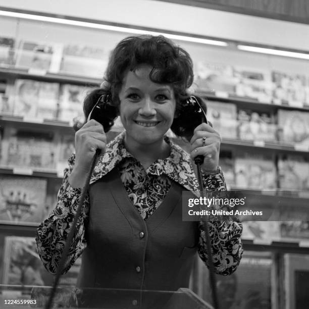 German singer and actress Lotti Krekel in a music store, Germany, 1970s.