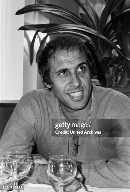 Italian singer and actor Adriano Celentano visiting an Italian restaurant at Hamburg, Germany circa 1982.