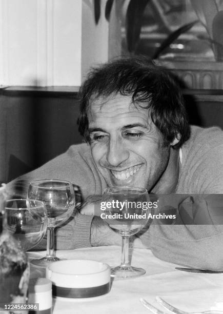 Italian singer and actor Adriano Celentano visiting an Italian restaurant at Hamburg, Germany circa 1982.