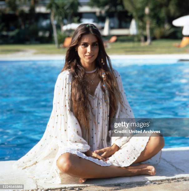 Home story of the Italian-American singer and actress Romina Power here posing by the pool, Cellino San Marco Italy mid 1980s.