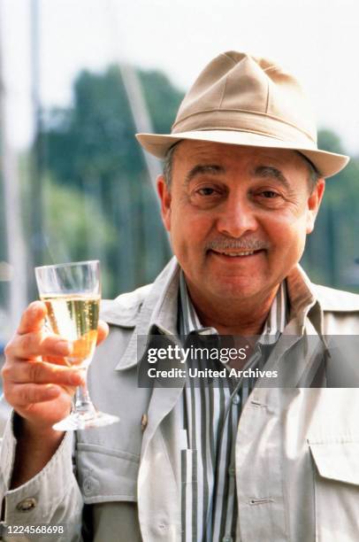 The American actor John Hillerman approves a drink circa 1990.