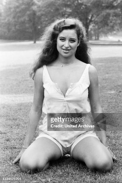 German singer, musical actress and TV host Isabel Varell posing for a photo shooting at a public garden, Germany circa 1984.