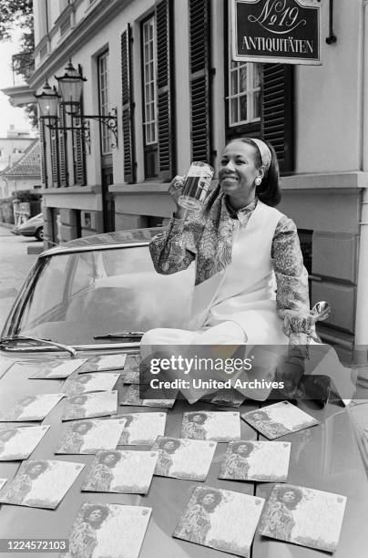 Dutch singer Sasi Naz visiting Germany posing on a Maserati with her latest single A NEVER ENDING MEDLOY, circa 1967.