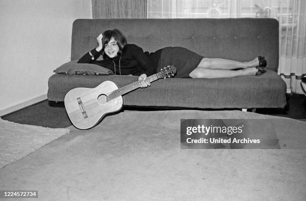 Greek German singer Vicky Leandros on a sofa in the beginning of her career at Hamburg, Germany circa 1965.