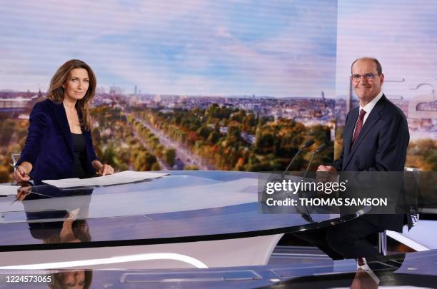 French journalist Anne-Claire Coudray and newly appointed French Prime Minister Jean Castex pose for pictures before taking part in the evening news...