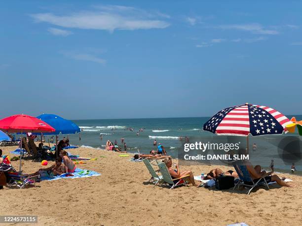 Tourist gather at the beach in Ocean City, Maryland, on July 3 as the US begins to celebrate Independence Day, during the coronavirus pandemic. - The...