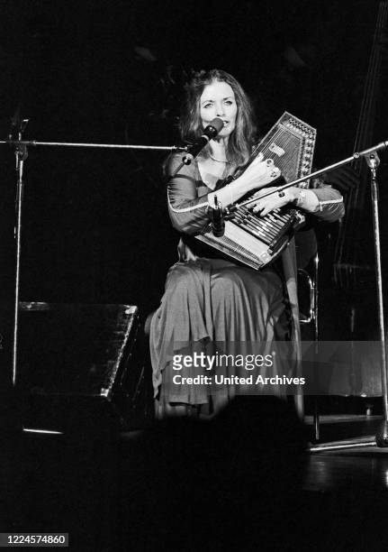 June Carter Cash, wife of American country singer and song writer Johnny Cash, playing a lyra while performing at Hamburg, Germany, circa 1981.