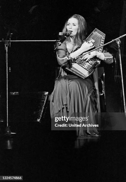 June Carter Cash, wife of American country singer and song writer Johnny Cash, playing a lyra while performing at Hamburg, Germany, circa 1981.