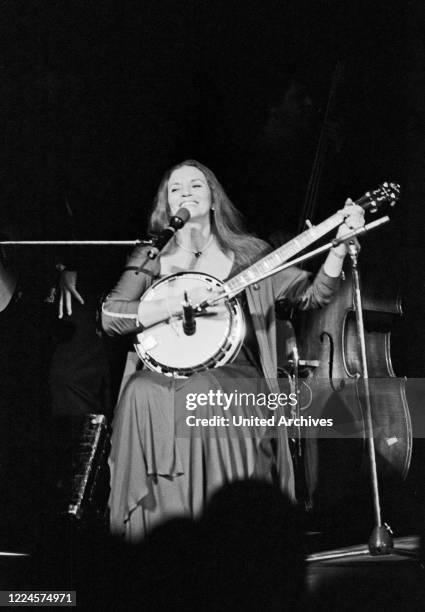 June Carter Cash, wife of American country singer and song writer Johnny Cash, playing banjo while performing at Hamburg, Germany, circa 1981.