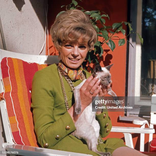 German actress Grit Boettcher with a cat, Germany, 1960s.