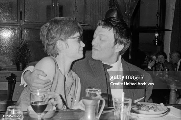 German business man and playboy Rolf Eden flirting in a restaurant, Germany, 1960s.