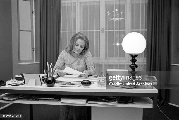 German Swiss actress Ruth Maria Kubitschek on her desk, Germany, 1960s.