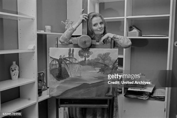 German Swiss actress Ruth Maria Kubitschek with one of her paintings, Germany, 1960s.