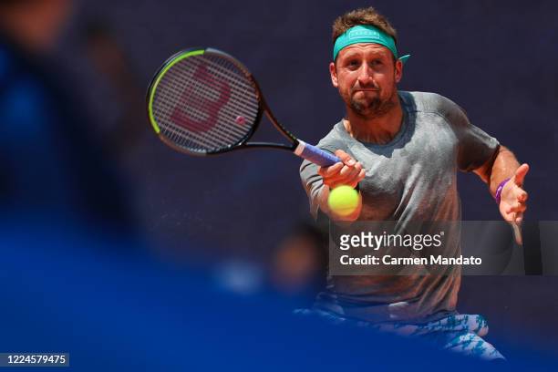 Tennys Sandgren of the United States returns a ball during the singles match against Tommy Paul during the DraftKings All-American Team Cup on July...