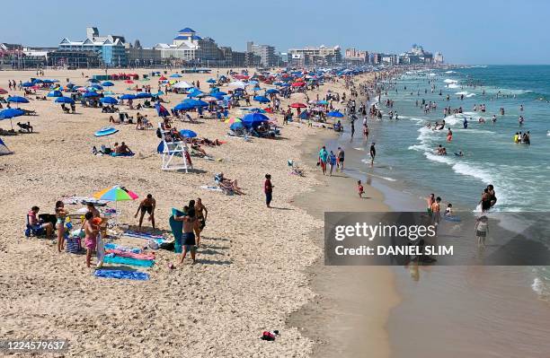 Tourist gather at the beach in Ocean City, Maryland, on July 3 as the US begins to celebrate Independence Day, during the coronavirus pandemic. - The...