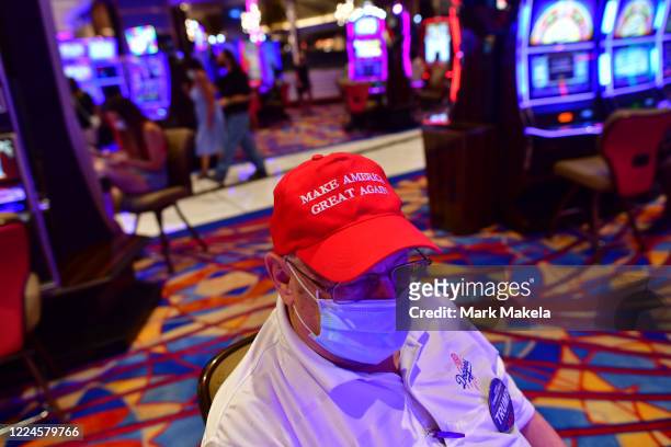 President Trump supporter wearing a "Make America Great Again" hat gambles at Hard Rock Casino after it reopened on July 3, 2020 in Atlantic City,...